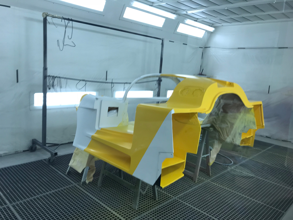 Toyota 88C body panels sprayed yellow and white in the paint booth